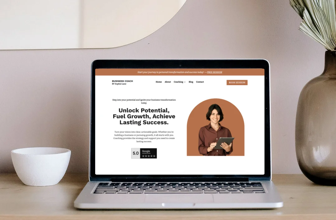 "A laptop mockup displaying the homepage of the Business Coach website. The hero section features a bold headline 'Unlock Potential, Fuel Growth, Achieve Lasting Success,' a professional coach portrait, and a clear 'Book Session' call-to-action button in the header for immediate conversion."