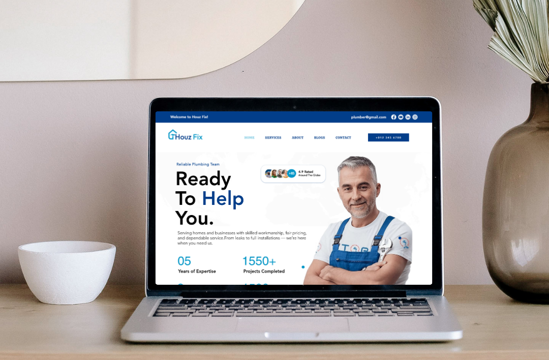 A high-quality laptop mockup on a modern wooden desk showcasing a Wix-based plumbing website for the brand 'Houz Fix'. The screen displays a professional blue and white landing page featuring an expert plumber's image, the headline 'Ready To Help You', and impressive business statistics including 1550+ completed projects, set in a bright and minimalist home office environment.