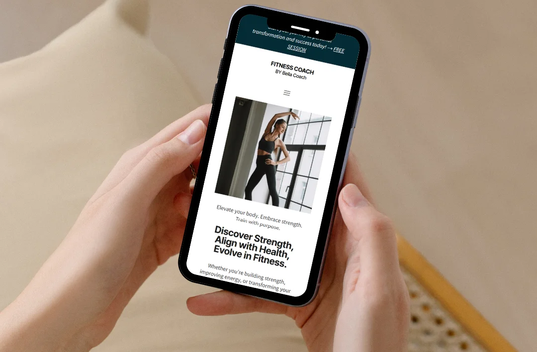 "A close-up of a smartphone displaying the mobile-responsive 'Fitness Coach' website template. The screen features a professional dark teal and white theme with an arched image of a trainer and the headline 'Discover Strength, Align with Health, Evolve in Fitness.' The design emphasizes a clean, motivational layout optimized for viewing on mobile devices."