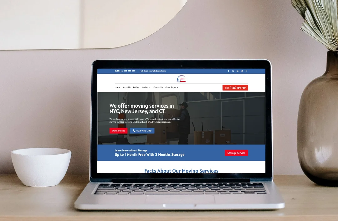 A professional laptop mockup displaying the 'Moving Services' website template. The screen features a clean blue and white theme with an image of a mover and the headline 'We offer moving services in NYC, New Jersey, and CT.' It highlights a prominent red 'Get a Quote Now' button and a blue 'Call Now' button. The laptop is placed on a modern wooden desk in a minimalist home office setting.
