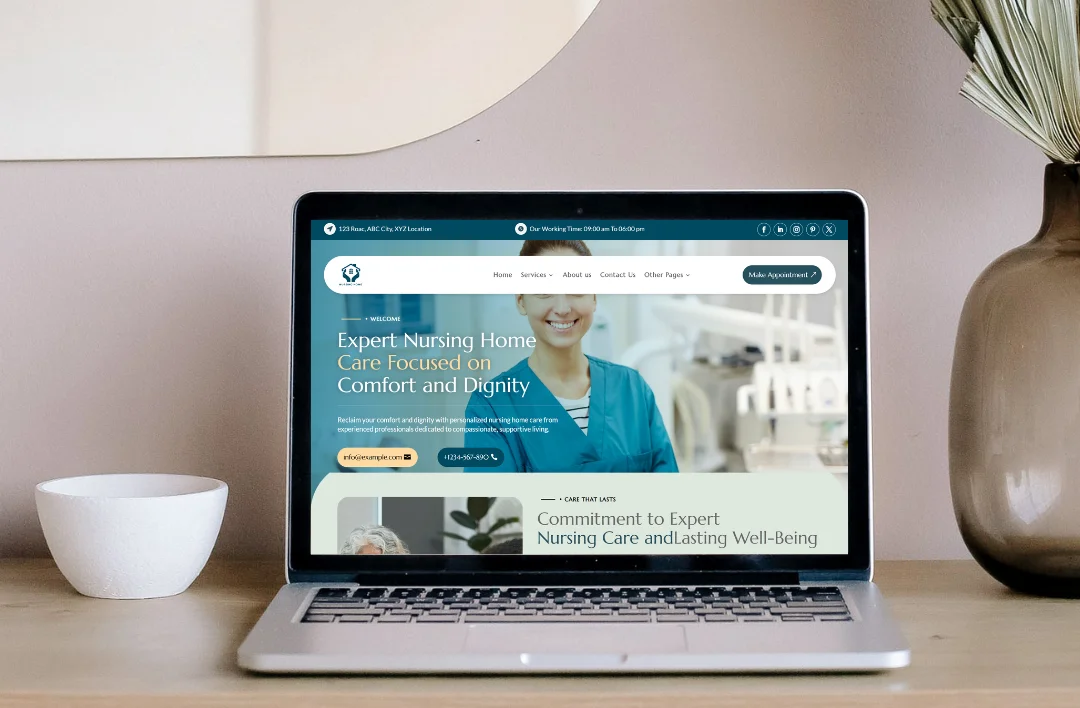 A professional desktop website mockup for a nursing home facility displayed on a laptop. The website features a teal and white theme with a hero image of a smiling nurse and the headline 'Expert Nursing Home Care Focused on Comfort and Dignity.' The layout includes a 'Make Appointment' button, contact information, and a section about their commitment to well-being, all presented in a clean, modern lifestyle setting.