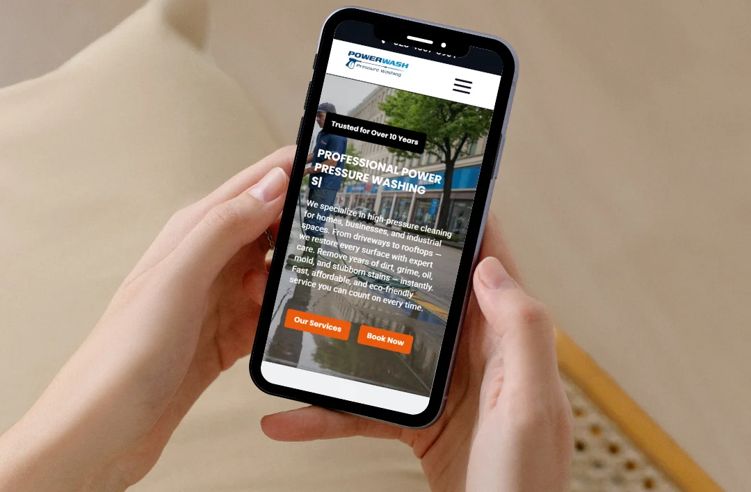 Mobile view of a professional pressure washing website showing service details and orange call-to-action buttons.