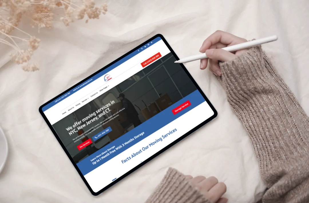 "A professional 'Moving Services' website template displayed on a tablet held by a user with a stylus. The screen features a crisp blue and white theme, an image of a professional mover, and the headline 'We offer moving services in NYC, New Jersey, and CT.' The layout includes a prominent red 'Get a Quote Now' button and a blue 'Call Now' button, designed for easy navigation on touch devices."