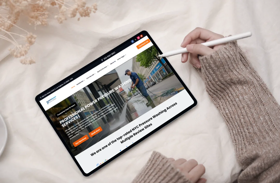 Tablet displaying a professional pressure washing WordPress website homepage with service details and call-to-action buttons.